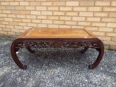 A Chinese coffee table with carved decoration, approximately 40 c, x 98 cm x 40 cm.