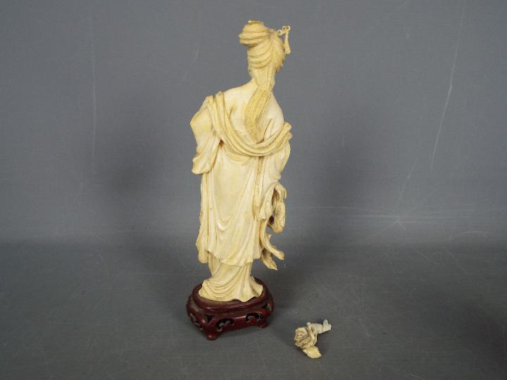 Two early 20th century ivory figurines comprising a fisherman and a courtesan (hand broken but - Image 6 of 6
