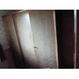 A triple wardrobe, dismantled for transportation, approximately 185 cm x 170 cm x 60 cm.