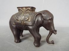 A vintage, cast iron, money bank in the form of an elephant,