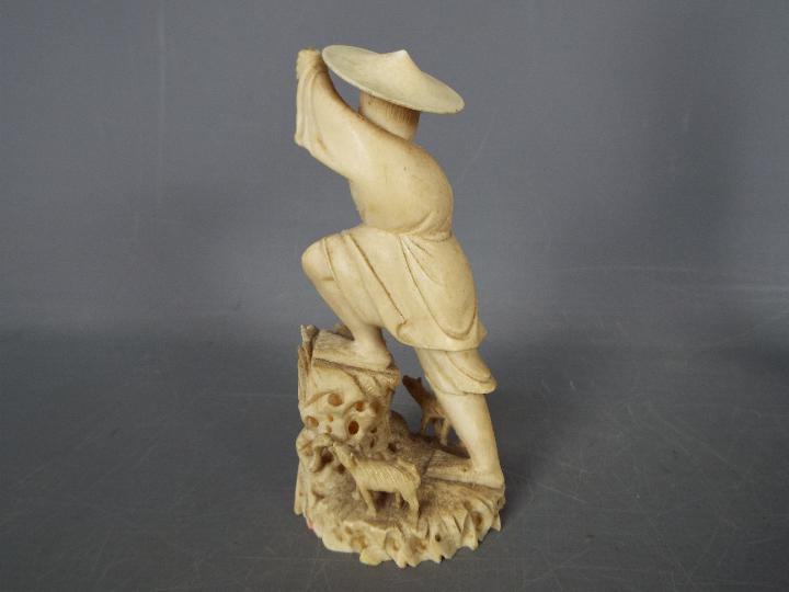 Two early 20th century ivory figurines comprising a fisherman and a courtesan (hand broken but - Image 3 of 6