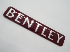 A red and chrome Bentley sign