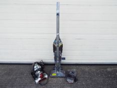 A Vax 'Air Cordless Switch' upright vacuum cleaner and a Dirt Devil handheld vacuum cleaner.