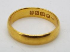 A 22ct gold wedding band, size O, approximately 4.8 grams all in.