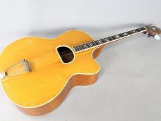 A vintage tenor guitar, marked to the headstock 'Millard'.