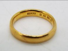 A 22ct gold wedding band, size I, approximately 4 grams all in.