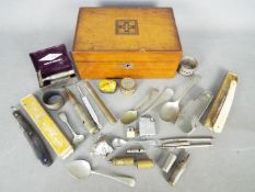 A wooden box containing a quantity of collectables including cut throat razors, napkin rings,