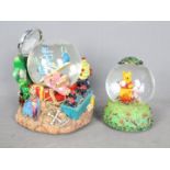 Two Disney musical snow globes comprising 'A Bug's Life' and Winnie The Pooh,