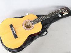 A Legend LEC8 children's acoustic guitar in soft carry case.