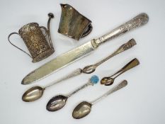 A small quantity of hallmarked silver spoons and tongs (66 grams all in), silver handled knife,