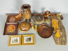 A collection of treen, carved wooden vase, walking stick and similar.