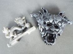 A Chinese soapstone dragon carving, 10 cm (h) and a wall mask.