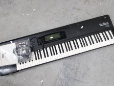 A Korg O1/W Pro keyboard synthesizer, with instruction manual.