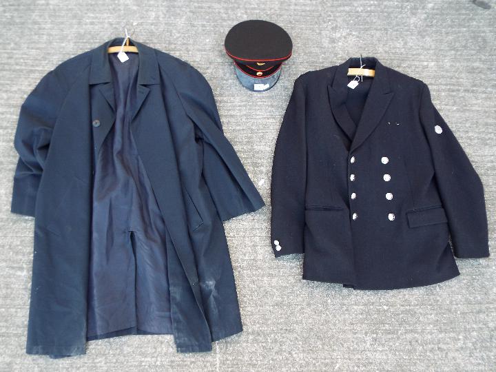 A jacket bearing fire brigade shoulder insignia and 'crossed axe and helmet' buttons,