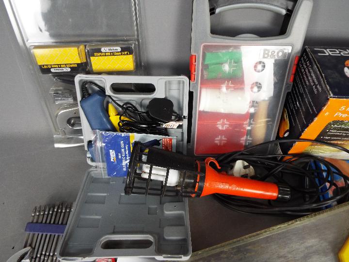 A selection of various tools to include a 5 in 1 air compressor, glue gun, hand saws and similar. - Image 2 of 4