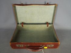 A small vintage briefcase or attache case.