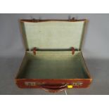 A small vintage briefcase or attache case.