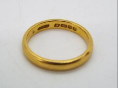 A 22ct gold wedding band, size M½, approximately 4.5 grams all in.