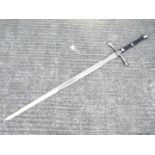 A replica two-handed broad sword with metal pommel and cross-guard, faux leather handle,