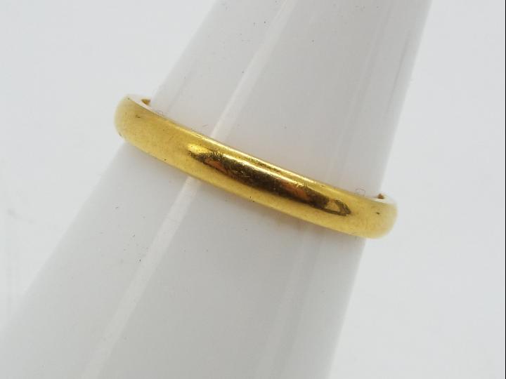 A 22ct gold wedding band, size N½, approximately 3.3 grams all in.