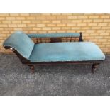 An upholstered chaise longue on turned supports having castors,