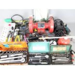 Lot to include a bench grinder, soldering iron, folding spade, hand tools and similar.