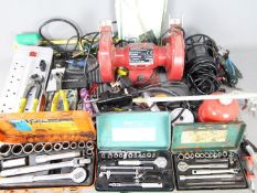 Lot to include a bench grinder, soldering iron, folding spade, hand tools and similar.