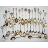 A collection of silver, souvenir collector spoons,