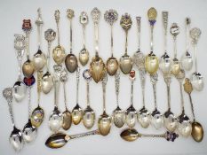 A collection of silver, souvenir collector spoons,