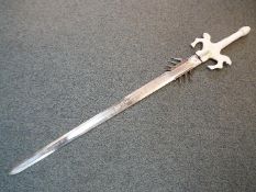 A fantasy double-edged two handed sword with spikes attached to blade,