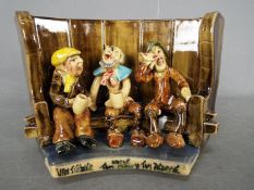 Runnaford Pottery - A Will Young 'Widecombe Fair' figural group of a three character bench