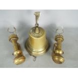 A wall mountable brass bell and two railway carriage lanterns.