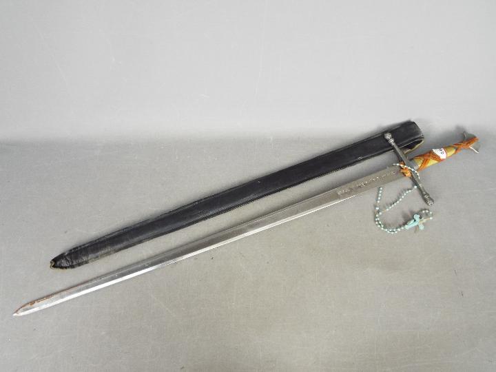 A replica Norse (Viking) sword with a runic inscription to the blade with wire wrapped handle and