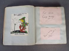 A vintage autograph book containing various signatures including George Formby, Kitty Masters,