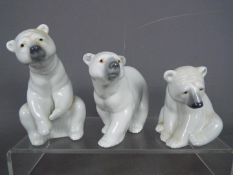 Lladro - Three Lladro polar bear figurines, largest approximately 12 cm (h).