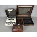 A vintage silk screen duplicator, Zephyr portable typewriter and a wooden box.