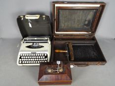 A vintage silk screen duplicator, Zephyr portable typewriter and a wooden box.