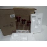 Unused Retail Stock - Five sets of three graduated red glass candle holders,