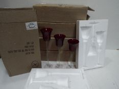 Unused Retail Stock - Five sets of three graduated red glass candle holders,