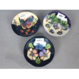 Moorcroft - Three Moorcroft coasters / pin dishes comprising a 2005 M.C.
