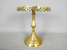 A good quality brass pedestal stand with pierced decoration, approximately 25 cm (h).