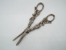 A pair of silver plated grape cutters