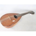 An early 20th century eight-string mandolin, unsigned, 59 cm length,