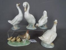 Four Nao geese figurines and a chicken group, largest approximately 15 cm (h).