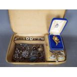 A jewellery box containing a quantity of brooches, rings, earrings,