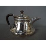 An Edward VII, Art Nouveau, hallmarked silver teapot with sinuous floral repousse decoration,