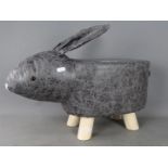 A footstool in the shape of a rabbit,