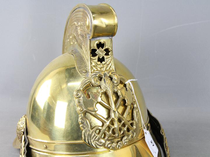 A fireman's brass helmet (reproduction). - Image 2 of 10