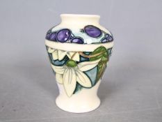 Moorcroft - A small Moorcroft Pottery vase decorated in the Juneberry pattern,