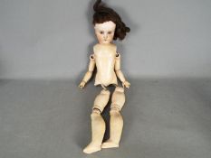 A German bisque head doll with sleeping eyes, open mouth, composition body,